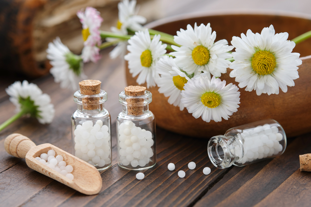 Bottles,Of,Homeopathy,Granules.,Homeopathic,Remedy,-,Chamomilla.,Daisies,Flowers